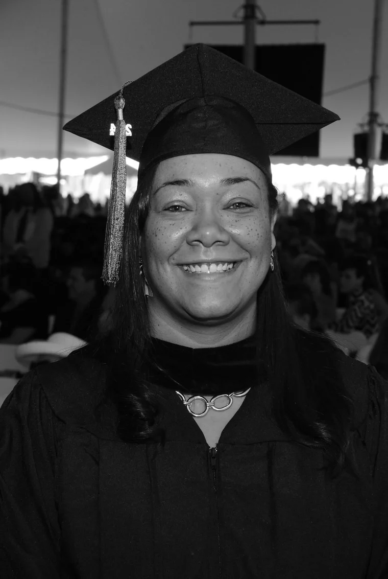 Ava smiling in her graduation cap and gown